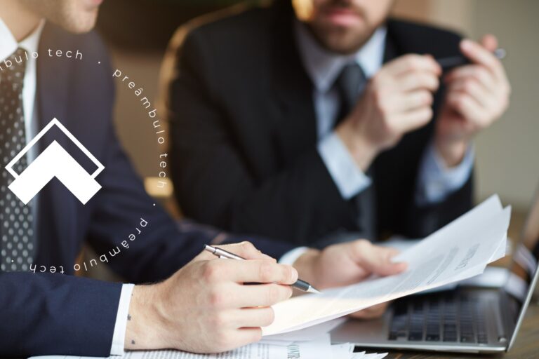 Advogados sentados à mesa enquanto um deles recebe orientações da assessoria jurídica.